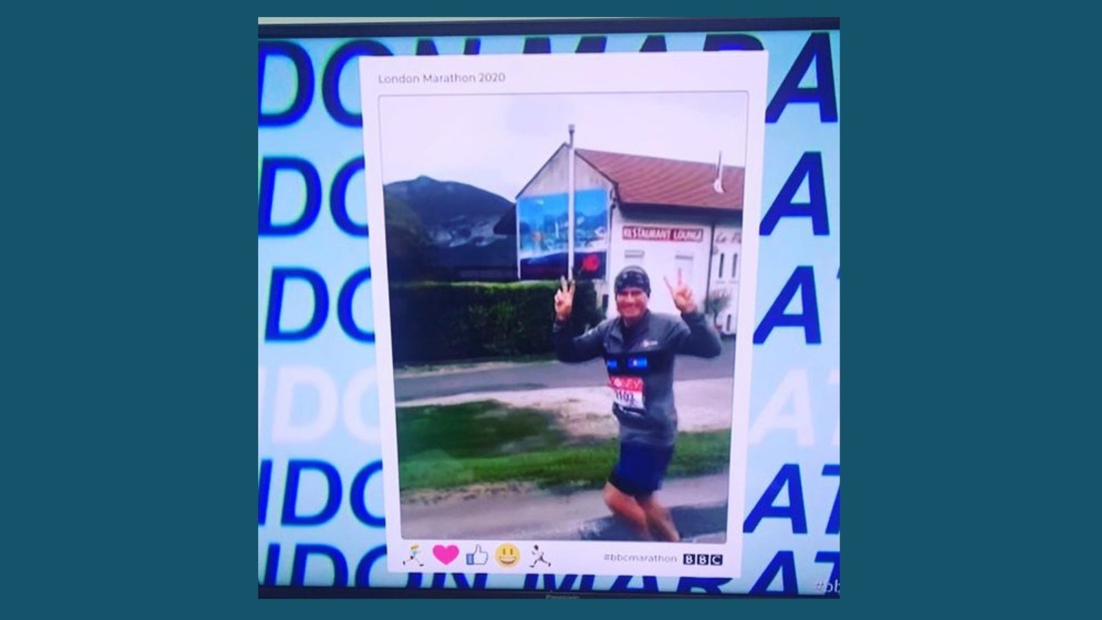 picture of Mark as seen on BBC coverage, jogging make a peace sign and smiling